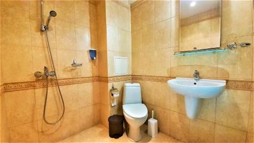 a bathroom with a shower and a toilet and a sink at Sunny Days - Park Apartment in Sandanski
