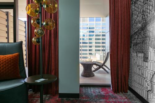 a living room with a couch and a window at Bobby Hotel in Nashville
