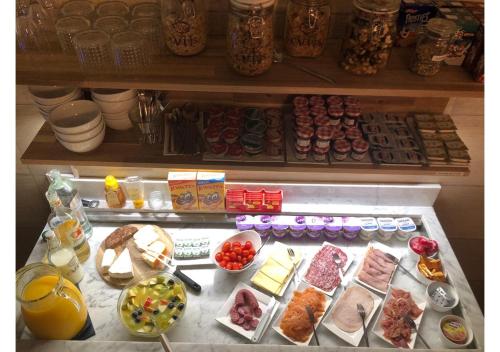 a refrigerator filled with lots of different types of food at Boutique Hotel Caelus VII in Tongeren