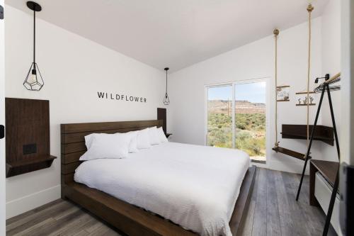 a bedroom with a large bed and a window at Zion Wildflower Resort in Virgin