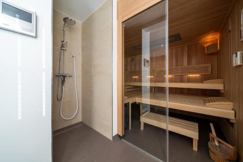 a bathroom with a walk in shower and a glass shower stall at Haus Heidelberg in Göhren