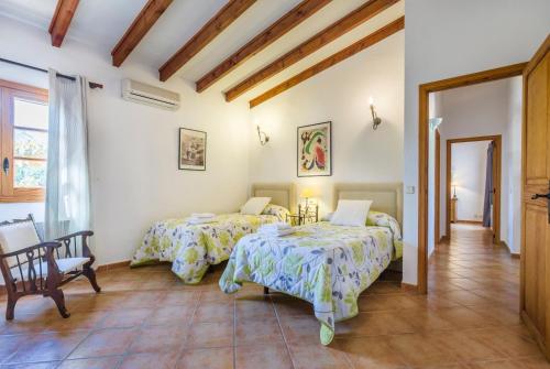 a room with two beds and a table at Villa Fullos by Sealand Villas in Pollença