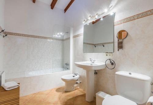 a white bathroom with a sink and a toilet at Villa Fullos by Sealand Villas in Pollença