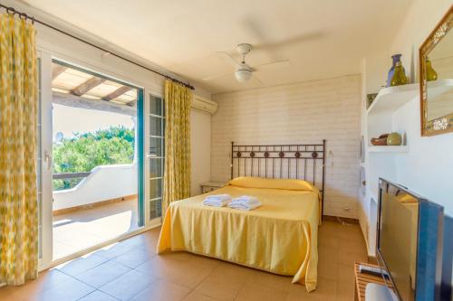 a bedroom with a bed and a large window at Villa Blau Mari in Muro
