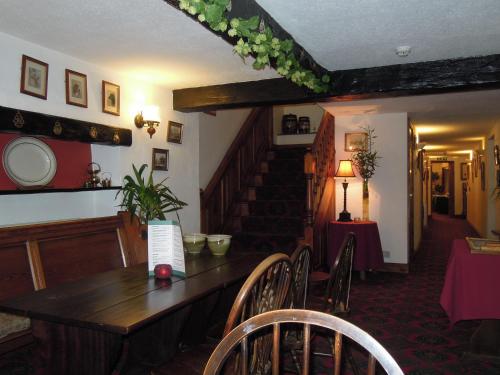 
a living room filled with furniture and a table at The Black Bull at Nateby in Kirkby Stephen
