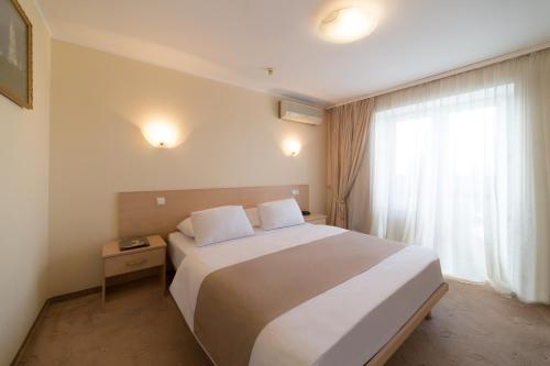 
a hotel room with a bed and two lamps at Hotel Express Congress in Kyiv
