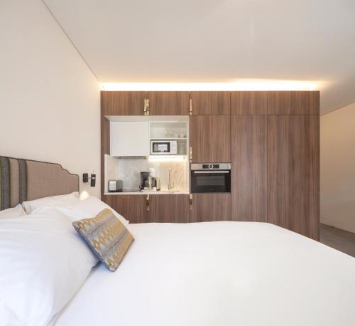 a bedroom with a white bed and white walls at Lisbon Serviced Apartments - Avenida in Lisbon