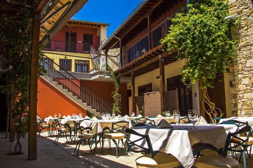 a restaurant with tables and chairs in a courtyard at The Library Hotel Wellness Retreat in Kalavasos