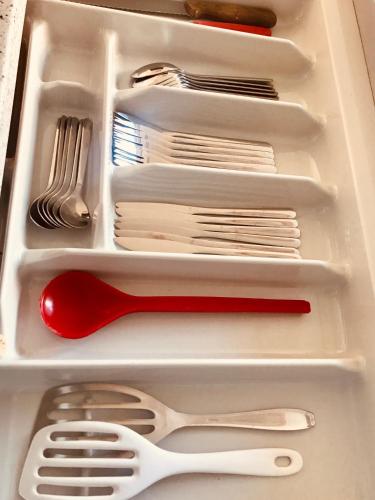 a white drawer with utensils in a refrigerator at Ferienzimmer in Allensbach in Allensbach