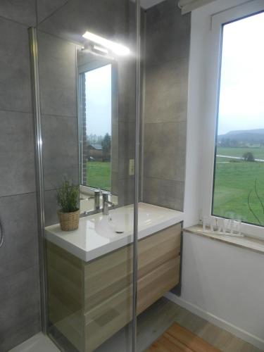 a bathroom with a sink and a window at Vic Va la Vie in Éprave