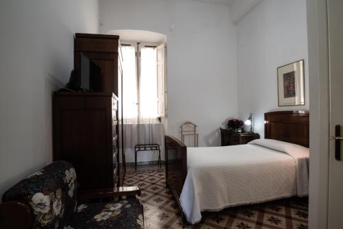 a bedroom with a bed and a tv and a window at Hotel AeR BJ Vittoria in Cagliari