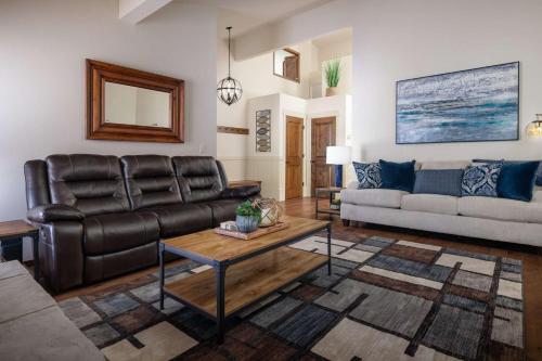 a living room with a leather couch and a table at Apollo Heights in West Linn