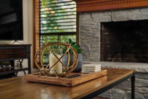 a table with a plant on it with a fireplace at Apollo Heights in West Linn