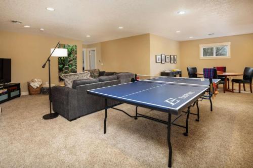 a living room with a ping pong table in it at Highland Gables in Beaverton
