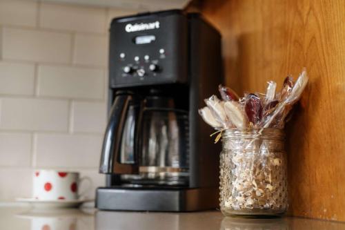 a coffee maker and a glass jar with a jar ofinoa at Highland Gables in Beaverton