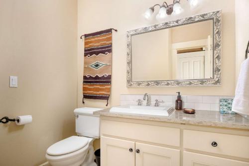 a bathroom with a toilet and a sink and a mirror at Highland Gables in Beaverton