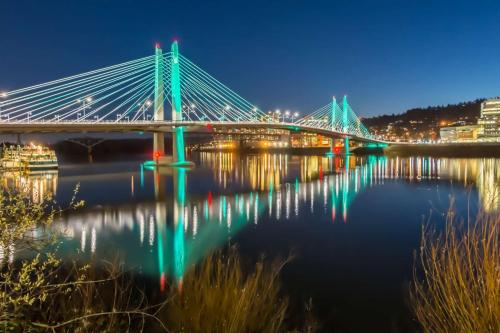 a bridge over the water at night at Highland Gables in Beaverton