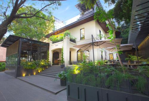 a house with a garden and a patio at Brick Hotel Mexico City - Small Luxury Hotels of the World in Mexico City