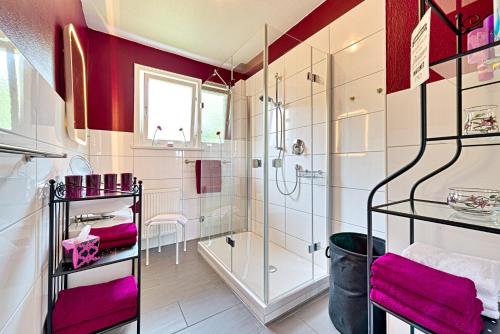 a bathroom with a shower and purple towels at Ferienwohnung Panoramablick Freudenstadt in Freudenstadt