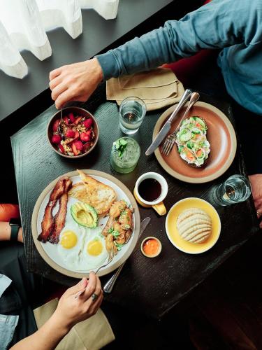 a table with a plate of breakfast food on it at The Hoxton, Portland in Portland