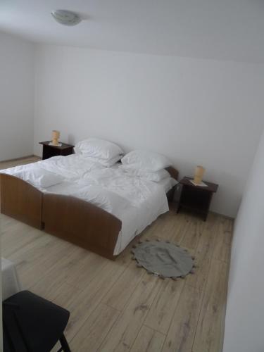 a bedroom with a bed and a wooden floor at Apartman Marija in Kastav