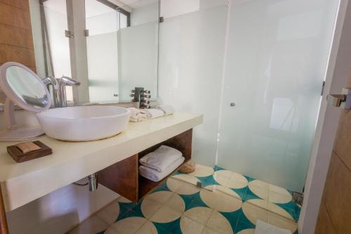 a bathroom with a sink and a toilet at O' Tulum Boutique Hotel - Adults Only in Tulum