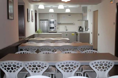 um quarto com mesas e cadeiras numa cozinha em Zubimuxu Aterpea em Goizueta