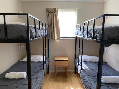 two bunk beds in a room with a window at NRMA Atherton Tablelands Holiday Park in Atherton
