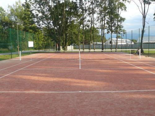 a tennis court with two people on it at Wellness Villa Liptov in Liptovská Sielnica