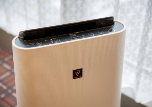 a laptop computer sitting on top of a refrigerator at Hotel Monterey Fukuoka in Fukuoka
