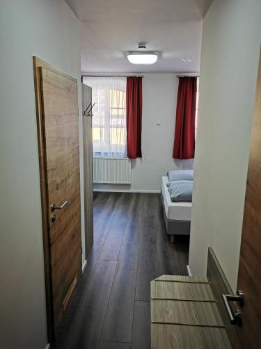 a room with a door and a bedroom with a bed at Pension unterm Schlossturm in Haag in Oberbayern