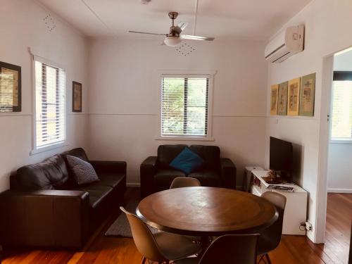 a living room with a couch and a table at Ella May Holiday Flats in Tuross Heads