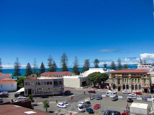 a town with cars parked in a parking lot at Napier Inner City Apartment - Napier Apartment in Napier