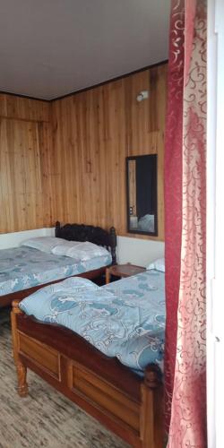 Postel nebo postele na pokoji v ubytování Vamoose Shri Ganesh Homestay