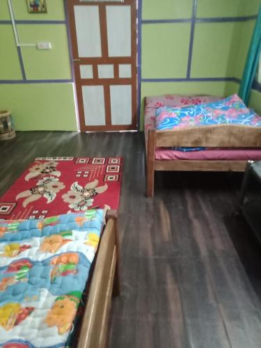 Postel nebo postele na pokoji v ubytování Vamoose Shri Ganesh Homestay