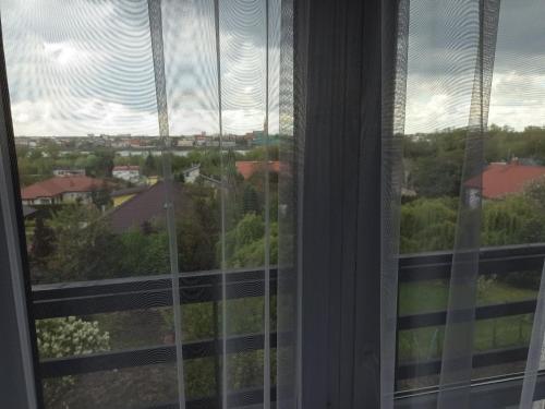 a window with a view of a city at Dom Gościnny "Zawiśle" in Włocławek