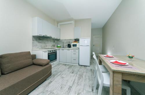a kitchen and dining room with a couch and a table at Теремки in Kyiv