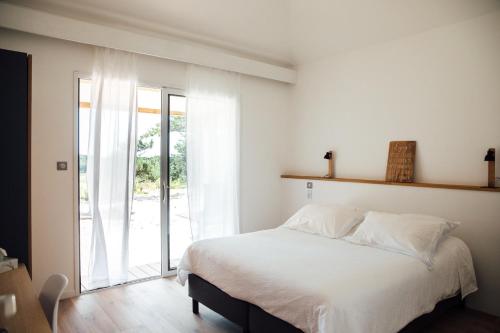 Ένα ή περισσότερα κρεβάτια σε δωμάτιο στο Le Lodge