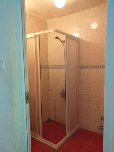 a shower with a glass door in a bathroom at Onur Pension in Fethiye