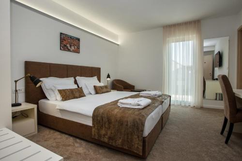 En eller flere senge i et værelse på Hotel Rotondo