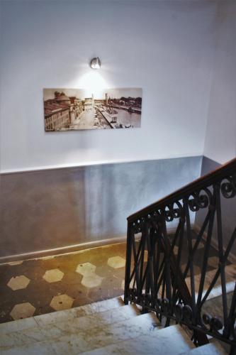 a picture hanging on a wall with a staircase at Domus Valadier B&B Guesthouse in Fiumicino