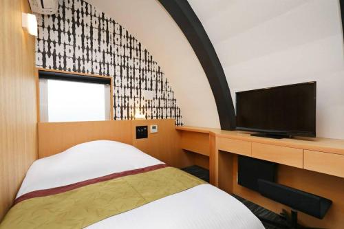 Un pat sau paturi într-o cameră la Hotel Matsunoi