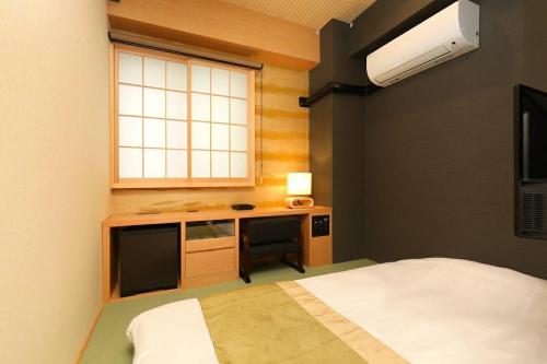 Vuode tai vuoteita majoituspaikassa Hotel Matsunoi
