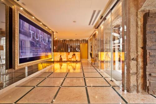 a hallway with a large screen in a building at TURIM Terreiro do Paço Hotel in Lisbon