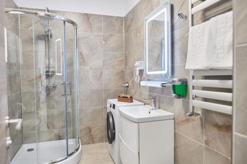 a bathroom with a shower and a toilet and a sink at Sea Love apt SPA n Pools Beach Resort in Mamaia Nord