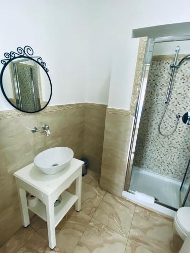 a bathroom with a sink and a shower at Domus Valadier B&B Guesthouse in Fiumicino
