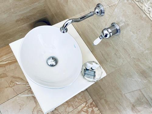 a white toilet in a bathroom with a sink at Domus Valadier B&B Guesthouse in Fiumicino
