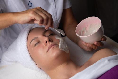 a woman in a spa getting a face massage at Luxury Spa Hotel Olympic Palace in Karlovy Vary