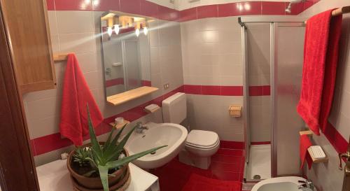 a bathroom with a toilet and a plant in it at Casa Ornella in Courmayeur