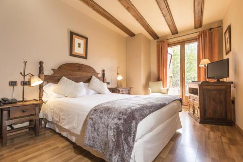 En eller flere senge i et værelse på Hotel Casa Cornel